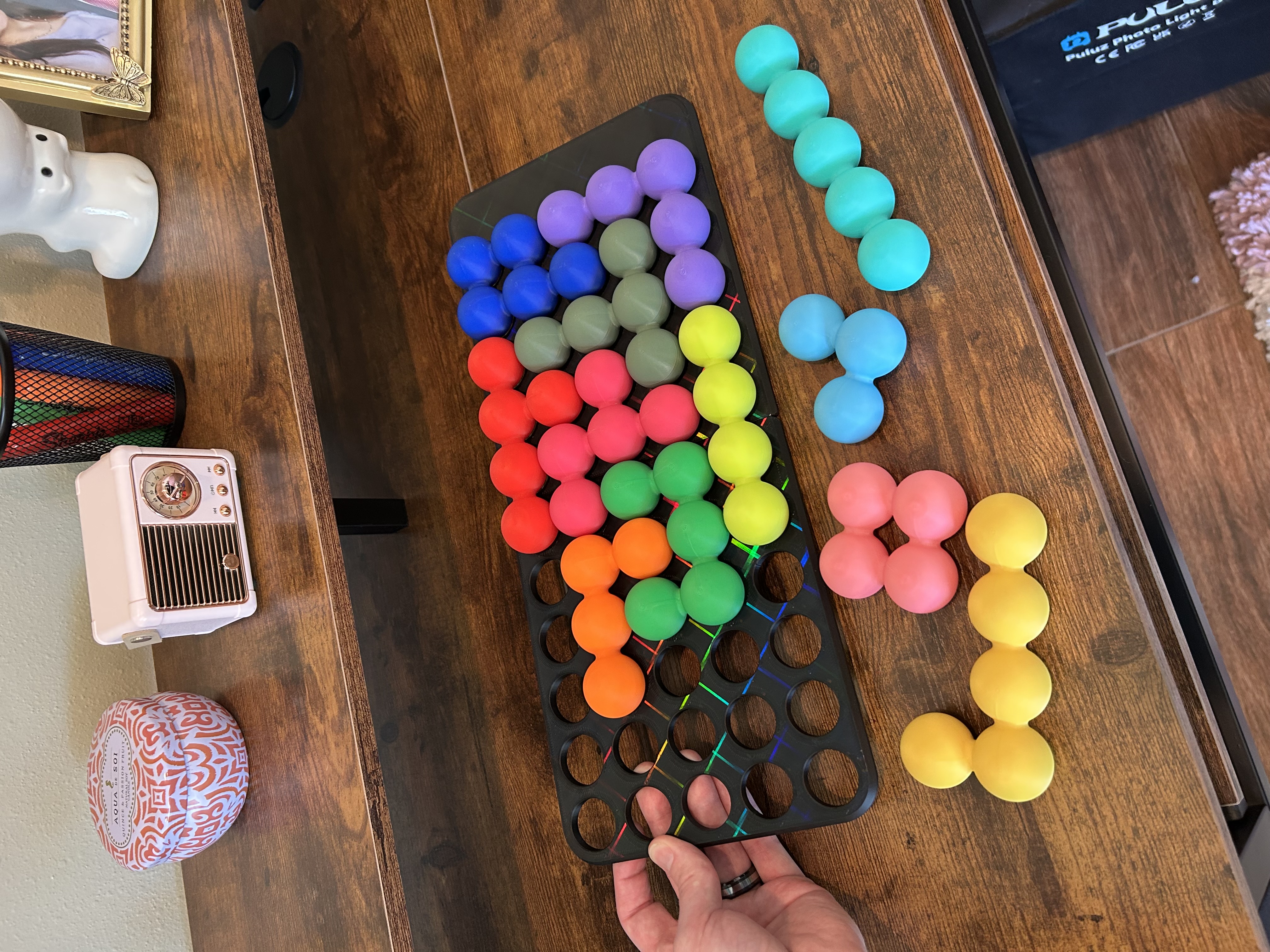 Katachi-Go puzzle tray, half-solved in rainbow colors, sitting out on a desk